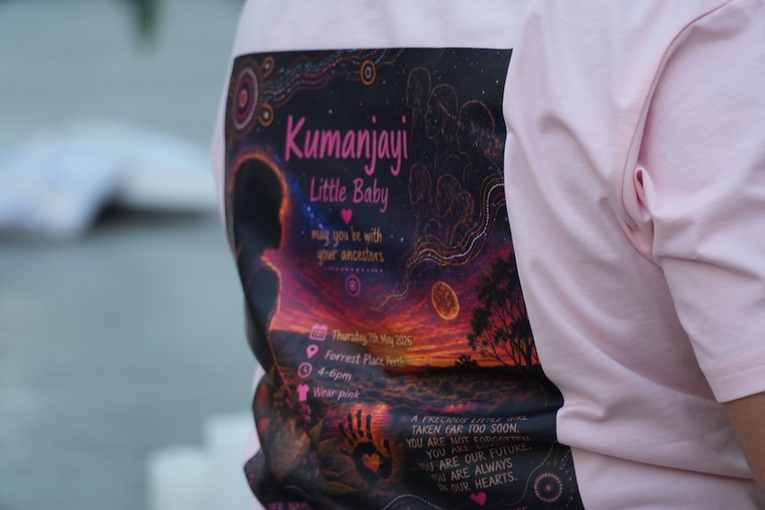 A t-shirt with Kumanjayi on it. The shirt is pink.