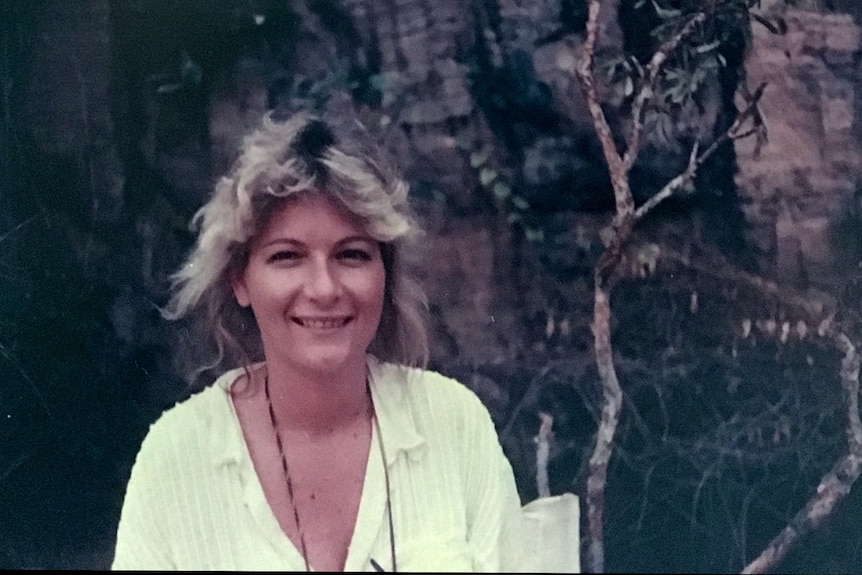 Photo from 1980s of young woman with blonde hair wearing white shirt