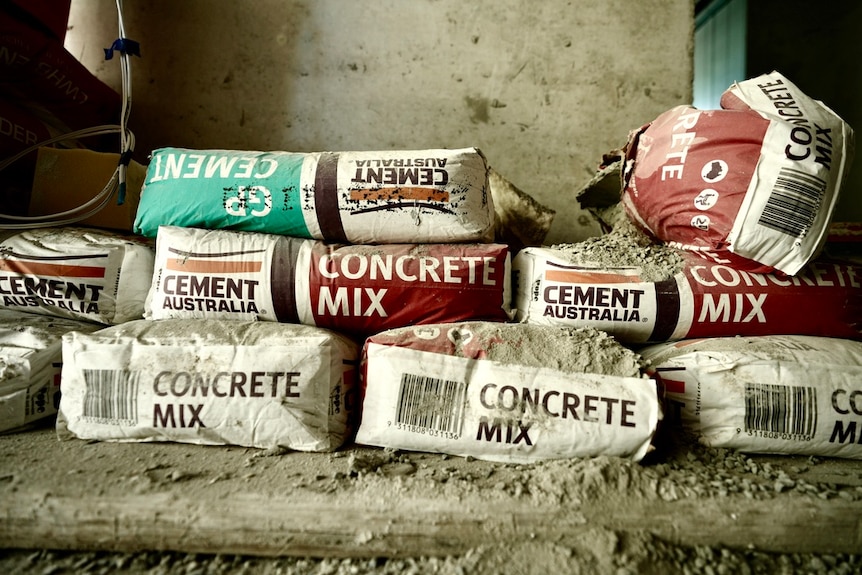 Bags of cement stacked together.