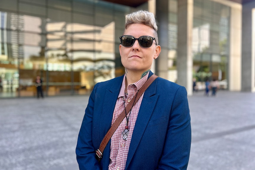 woman with short hair outside court
