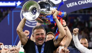 Paris St-Germain manager Luis Enrique smiling with the Champions League trophy