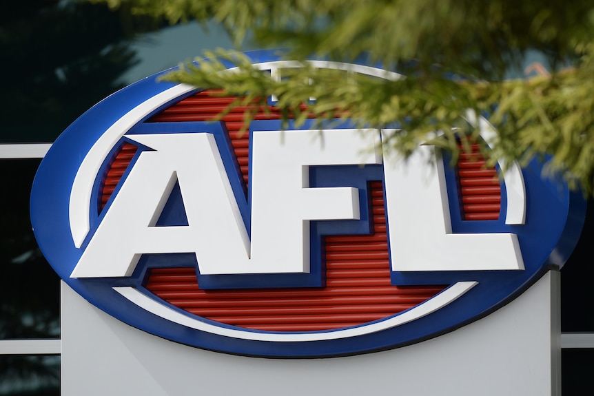 The AFL logo on the side of a building, partially obscured by a tree branch.