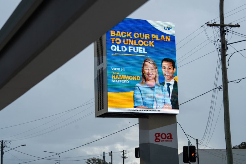 An election sign showing a blonde woman posing with a man.