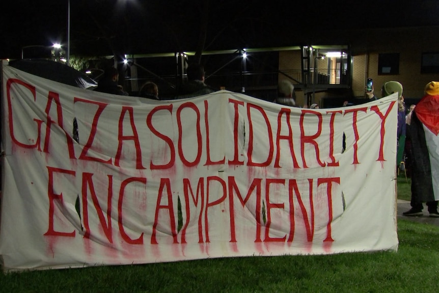 A banner with Gaza solidarity encampment painted on.