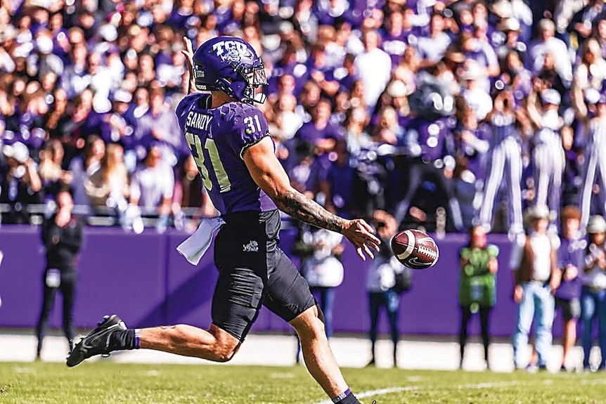 American football player kicking a ball