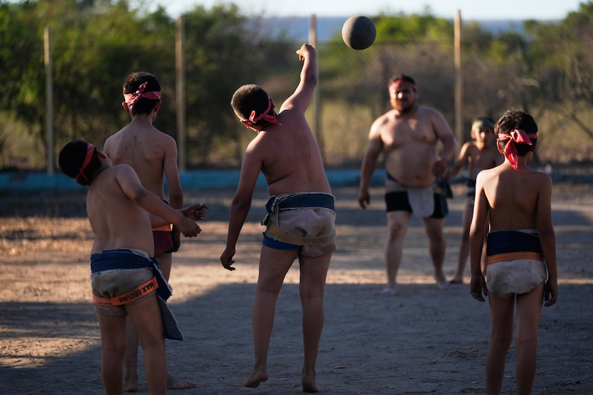 A group of boys play ulama
