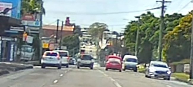 Dashcam captured the red sedan travelling on the wrong side of the road.