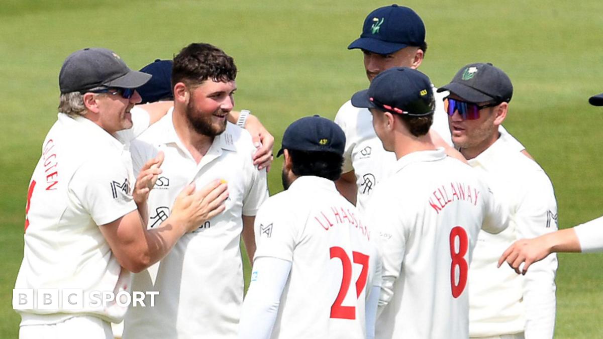 Tom Norton is congratulated by his Glamorgan team-mates