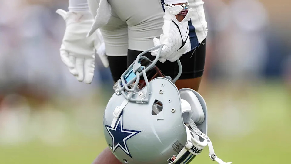 A <a class="link " href="https://sports.yahoo.com/nfl/teams/dallas/" data-i13n="sec:content-canvas;subsec:anchor_text;elm:context_link" data-ylk="slk:Cowboys;sec:content-canvas;subsec:anchor_text;elm:context_link;itc:0" data-yga="{"yLinkElement":"context_link","yModuleName":"content-canvas","yLinkText":"Cowboys","ySubModuleName":"anchor_text","yHasCommerce":false}">Cowboys</a> helmet at training camp.Icon Sportswire&sol;Getty Images