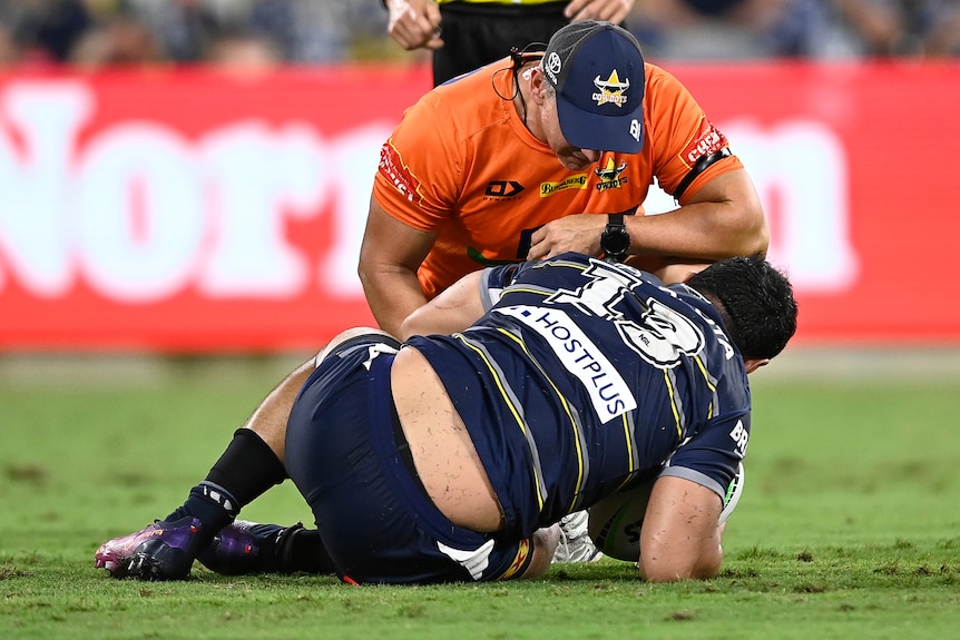 Jason slumps to the ground injured during a rugby league match.