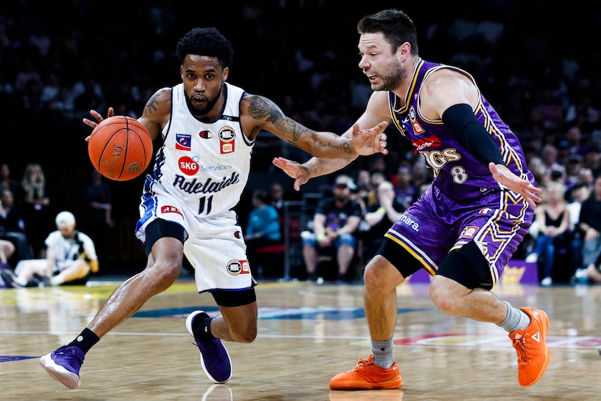 Bryce Cotton dribbles the ball for the 36ers as the Kings' Matthew Dellavedova defends in the NBL Championship Series opener.