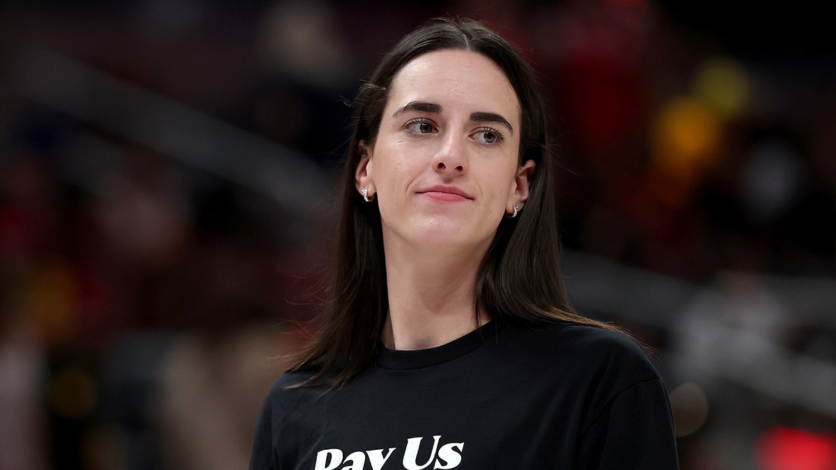 Caitlin Clark of the Indiana Fever wearing a shirt with Pay us what you owe us text