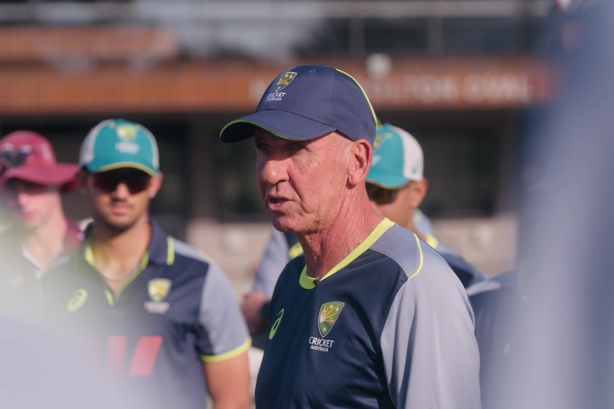 Cricket coach Tim Nielsen with young players at a training camp.