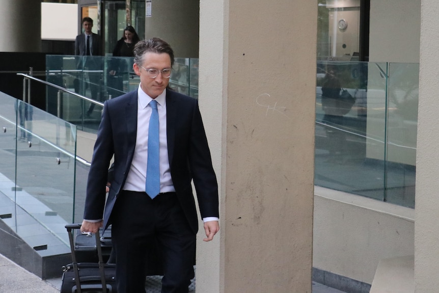 Prosecutor James Bennett walks outside court.