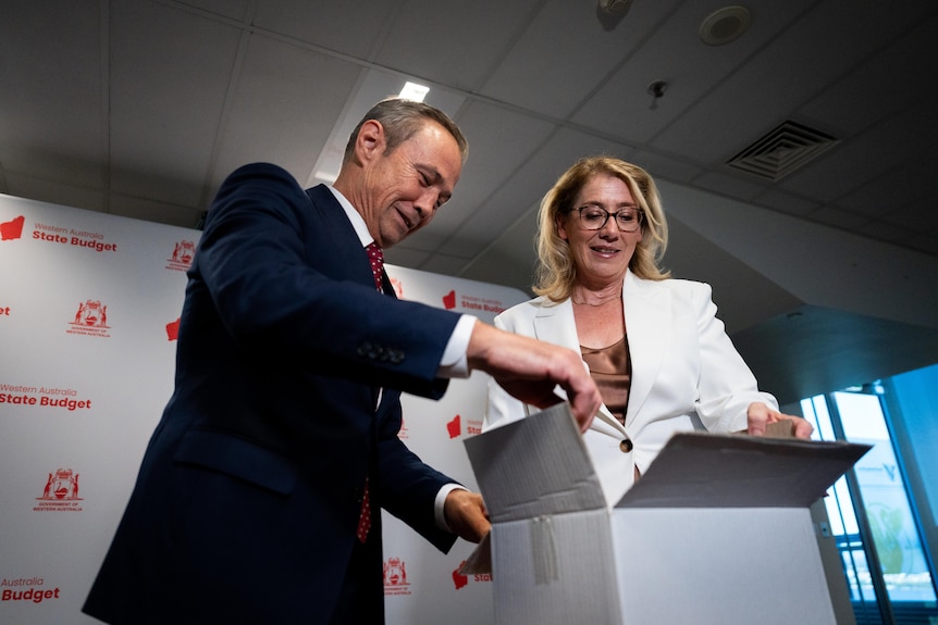 Rita and Roger pull the budget out of a box