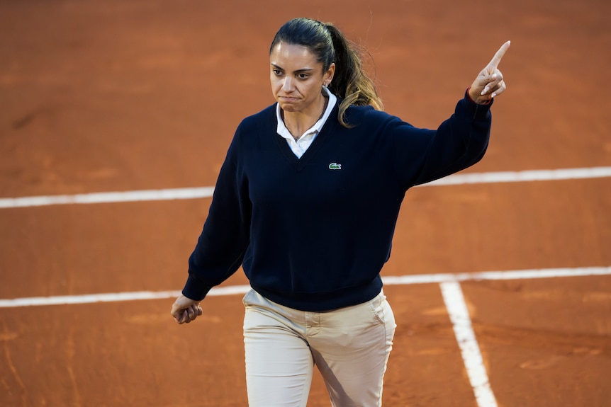 Ana Carvalho points out with her left hand