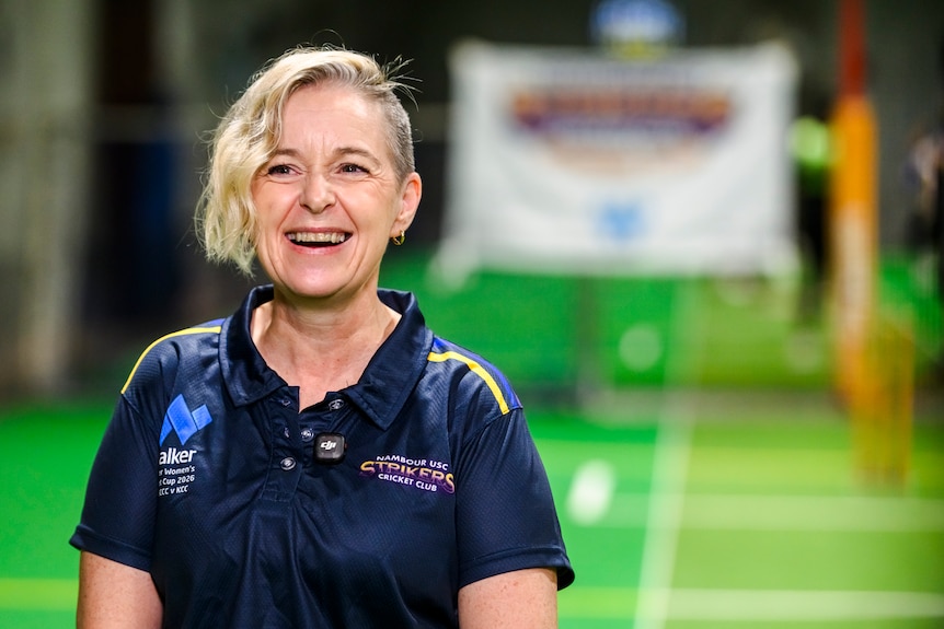 Woman smiling in indoor cricket club