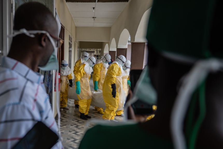 Red Cross workers prepare the body of an Ebola victim at Sofepadi Hospital for burial, in Bunia, DRC, Saturday, May 23, 2026. (AP Photo/Moses Sawasawa)