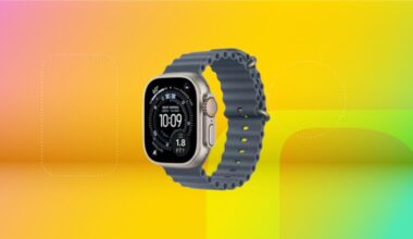 Apple Watch Ultra 3 with titanium blue wrist band displayed against a gradient orange, yellow and green backgound