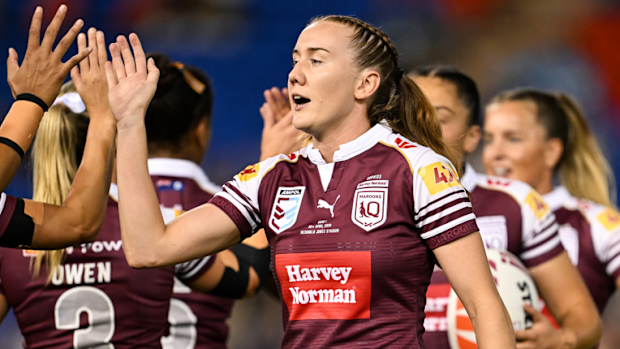 Tamika Upton celebrates with teammates after a Maroons try.