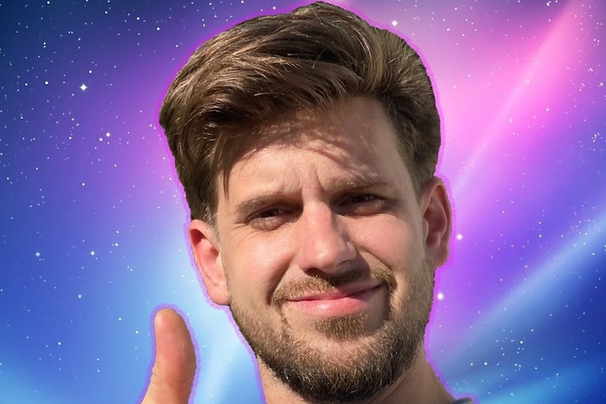 A man with light brown hair and a beard giving a thumbs-up in front of a galaxy-like background
