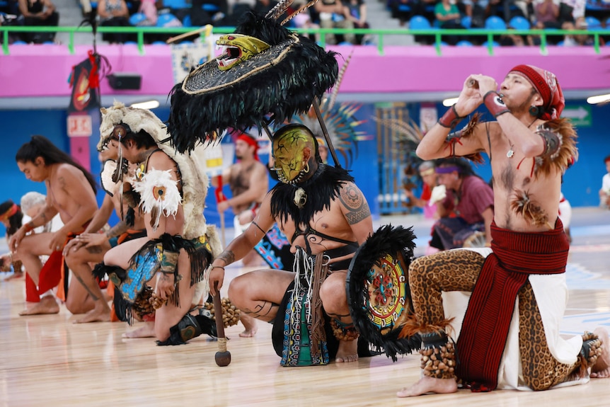 COstumed performers pose