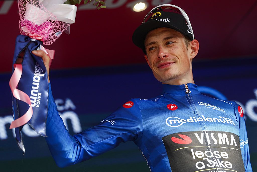 Team Visma Lease a Bike Danish rider Jonas Vingegaard celebrates with the best climber's blue jersey on the podium of the 12th stage of the Giro d'Italia 2026