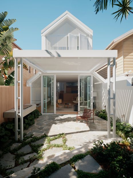 The lush greenery of the garden pops against the crisp white exterior.