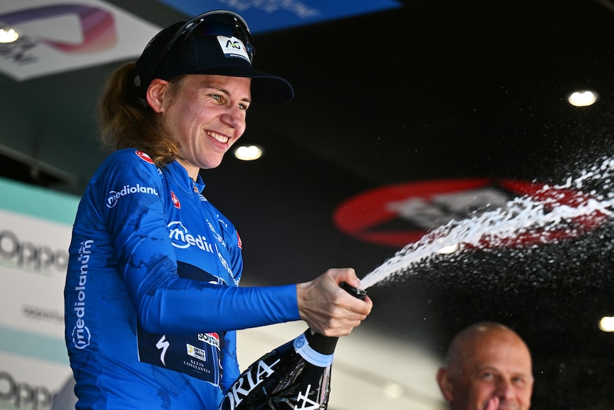 Sarah Gigante sprays champagne