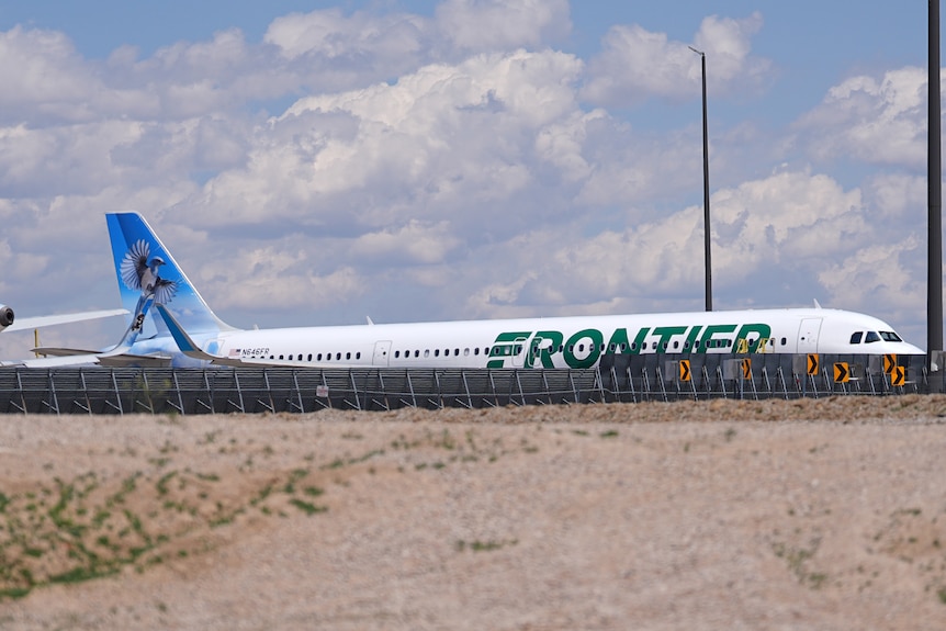 A plane bearing the Frontier logo sits on the tarmac at the technical operations centre.