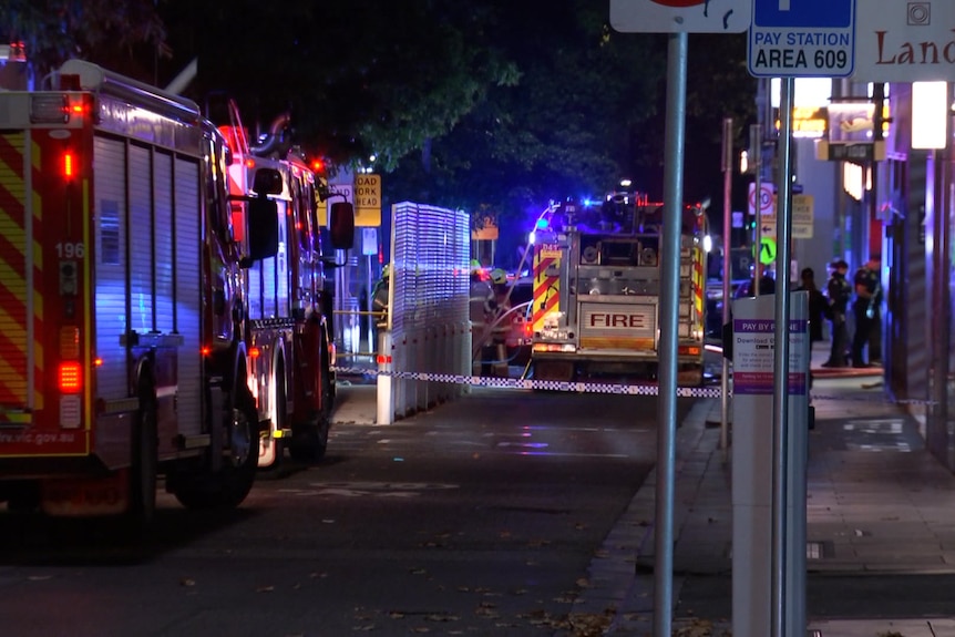 Fire trucks parked on a city street.