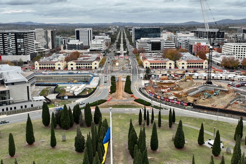 An aerial view of an arterial road with significant construction work occurring on either side.