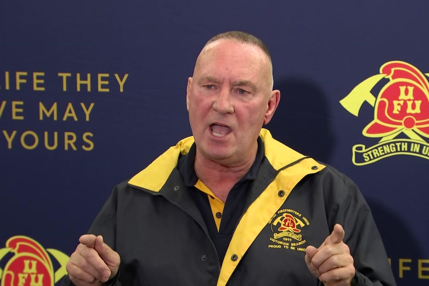 Peter Marshall wears a navy and yellow