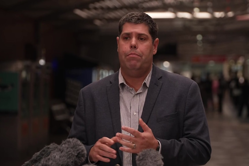 Brent Mickelberg speaks at a press conference at Brisbane's central station.