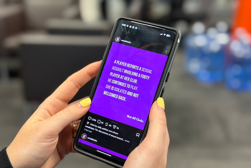 Someone holding a phone loaded to the Instagram profile of Not All Clubs.