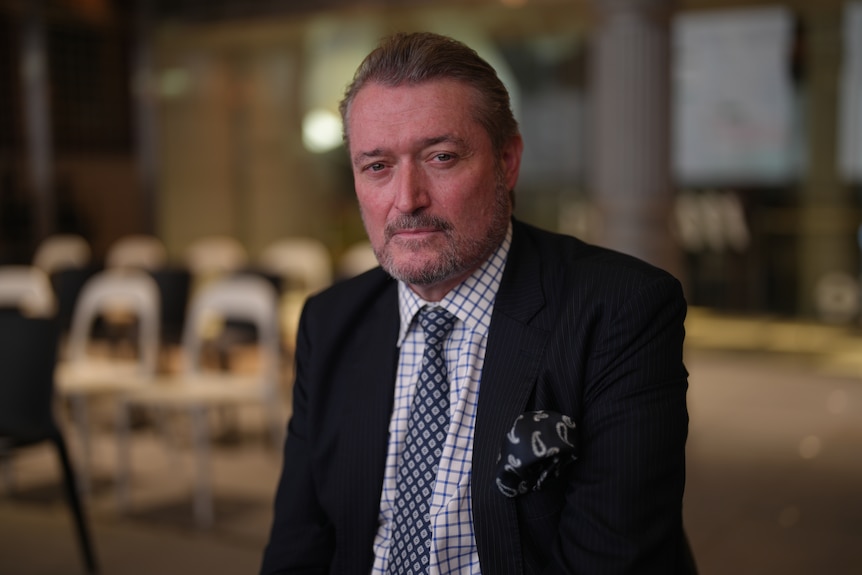 A man in a suit sitting down.