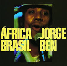 Album cover featuring a blurry photo of a hatted man singing into a microphone while looking at the camera