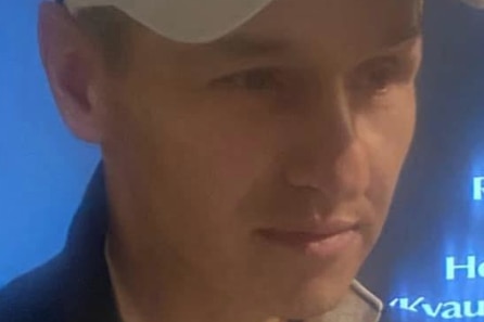 Picture of man wearing a white cap with sunglasses on top