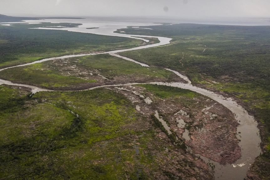 A photo of a winding river leading to the ocean