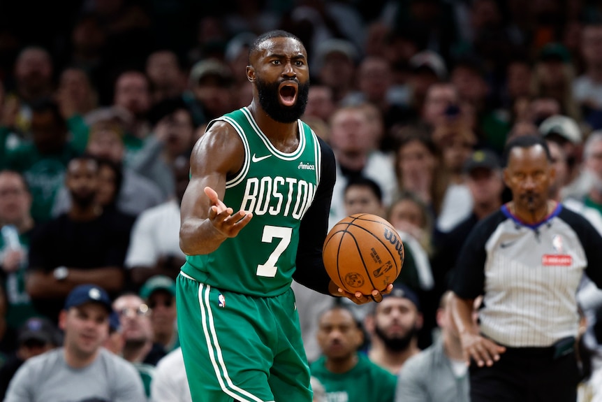 Jaylen Brown holds ball in left hand and gestures