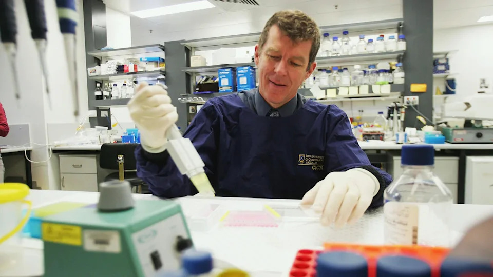 Professor Ian Frazer working with lab equipment
