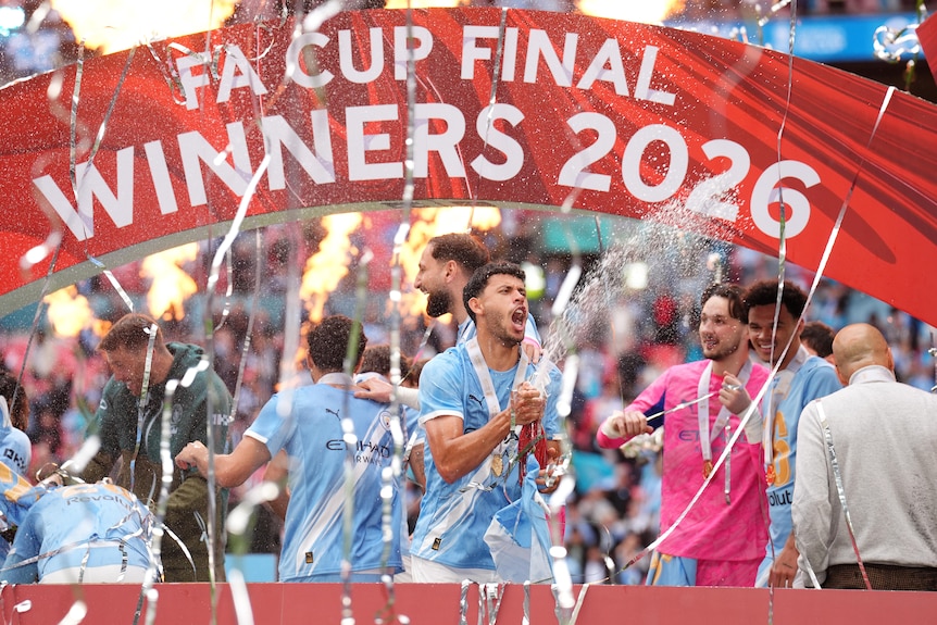 Manchester City's Matheus Nunes sprays champagne to celebrate winning the FA Cup.