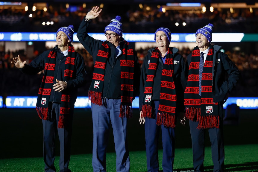 Chris, Anthony, Neale and Terry Daniher wear FightMND beanies and Essendon scarves.