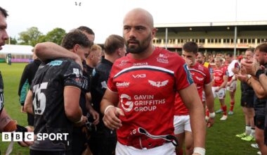 Josh Macleod leads Scarlets off the field at Ospreys