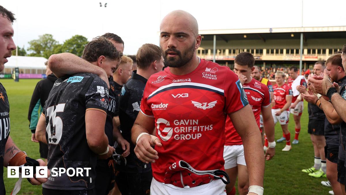 Josh Macleod leads Scarlets off the field at Ospreys