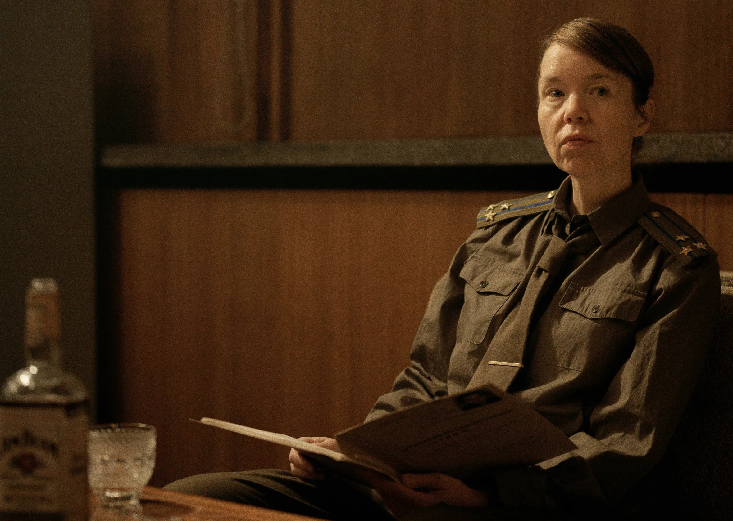 Anna Maxwell Martin as Lyudmilla Raskova, wearing a military uniform and holding a document.