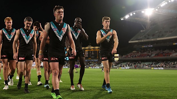 Zak Butters leads his team off after their loss to the Western Bulldogs.