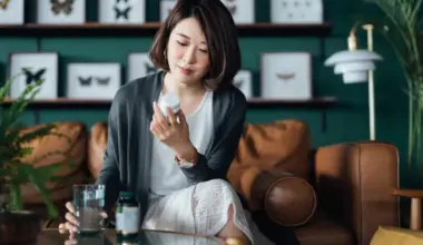 Best probiotics for women in Singapore: Asian woman reading labels on a bottle