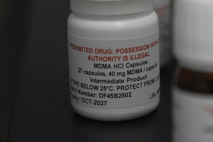 A white pill bottle labelled MDMA