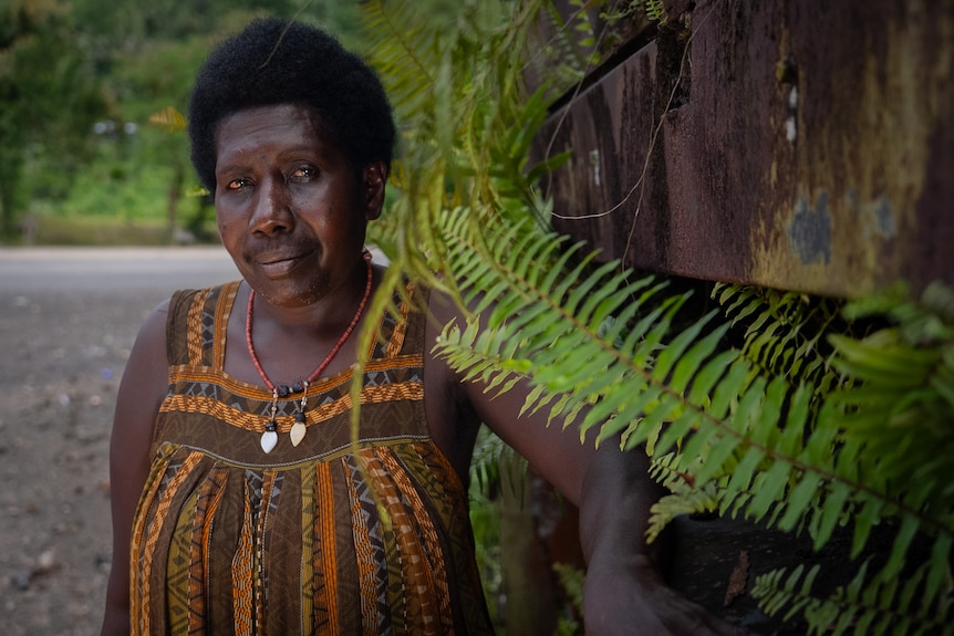 A close up photo of Beverley Ittamari wearing a dress with a necklace on.